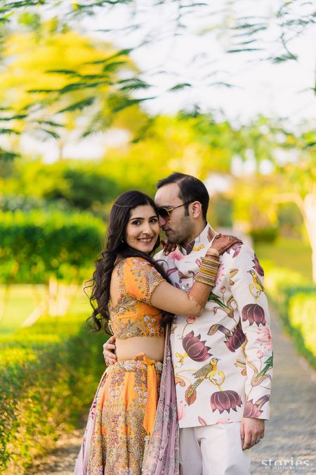 Photo of Bride and groom on mehendi function with floral print