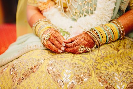Bridal hands on yellow gota patti lehenga
