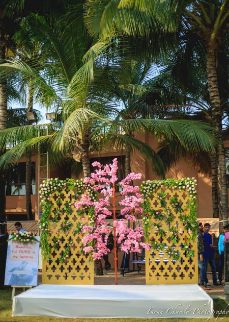 Photo of pink and gold and green outdoor small stage