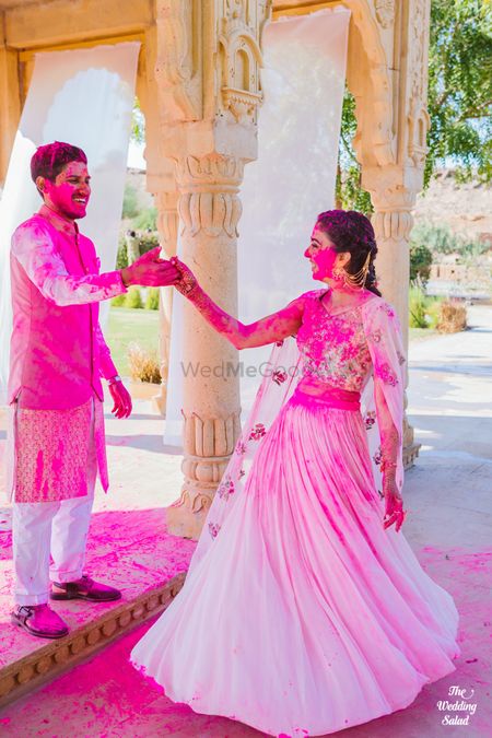 couple shot drenched in holi colours on their mehendi