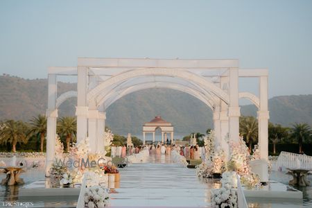 Photo of All white entrance decor with white florals and walkway.