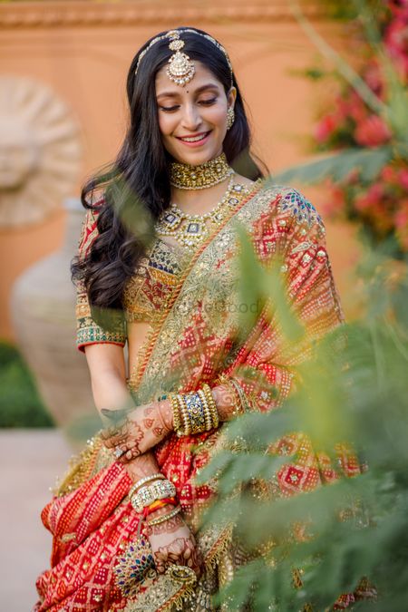 Bride wearing a multi-coloured lehenga.