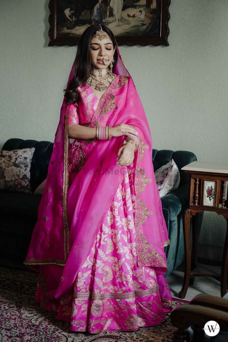 bride for her home wedding in pink banarasi lehenga with minimal jewellery