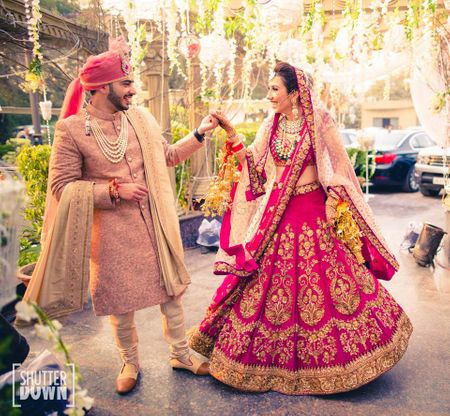 Bride and groom in fuschia pink coordinated outfits