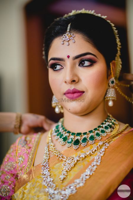 Layered diamond and emerald necklaces for South Indian bride 