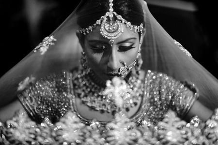 Classic bridal portrait in black and white with dupatta as veil