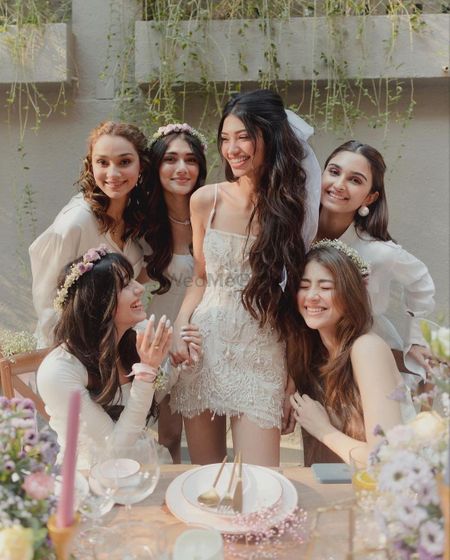 Alanna with her bridesmaids in white outfits. 