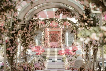 Gorgeous floral mandap in pastel theme with an arch-style entrance tunnel with lotus decor