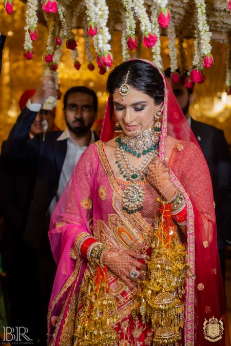bridal entry in red lehenga and unique jewellery
