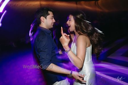 Photo of Candid capture of the bride and groom dancing at the after party
