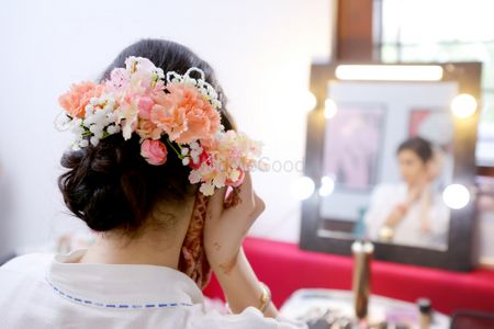 Pretty bridal bun with lots of florals 