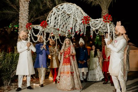 Photo of Grand bridal entry under a big phoolon ki chaadar