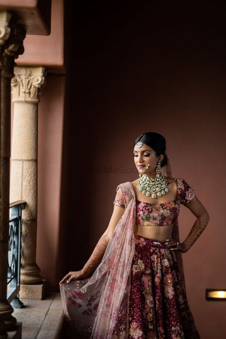 Photo of bride in floral embroidered lehenga in marsala by sabyasachi