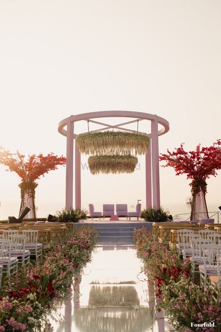 Gorgeous modern style pink and white outdoor mandap with floating floral decor