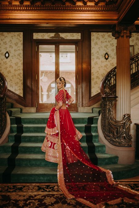 Photo of bridal portrait in a classic red and gold sabyasachi lehenga