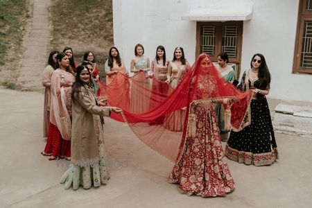Lovely shot of the bride holding her veil with her bridesmaids holding her train