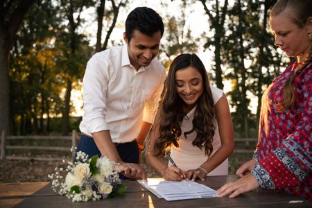 couple signing papers during their intimate court wedding