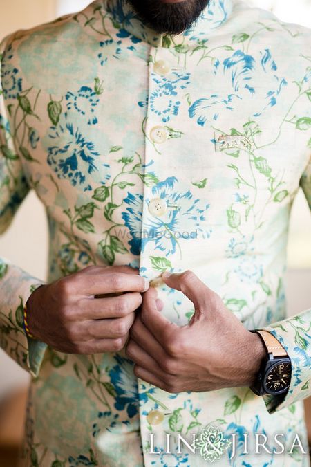 Off-white floral sherwani with blue and green flowers