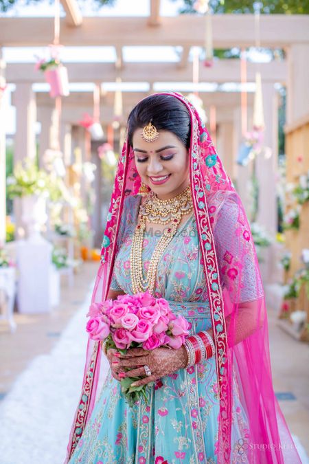 sikh bride in offbeat outfit holding a bouquet