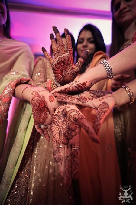 Photo of Fun Bridesmaids Photo with Words in Mehendi