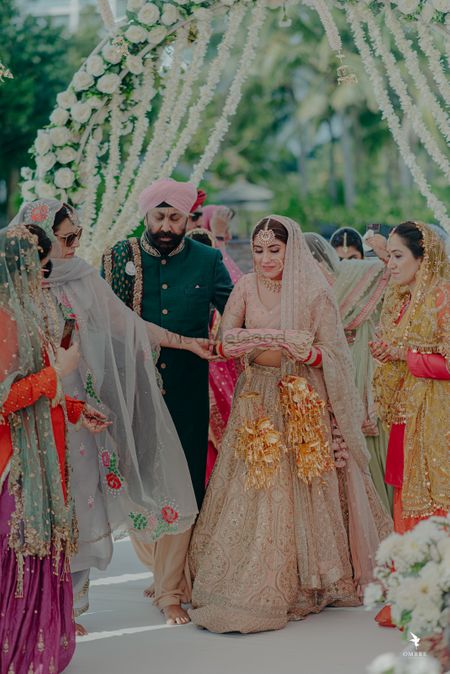 A bride entering for her Anand Karaj, along with her father 