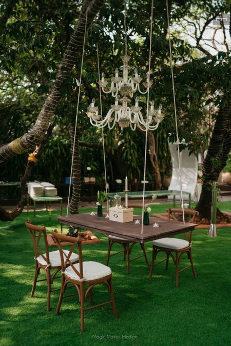 Photo of Unique floating table setting with a gorgeous white chandelier