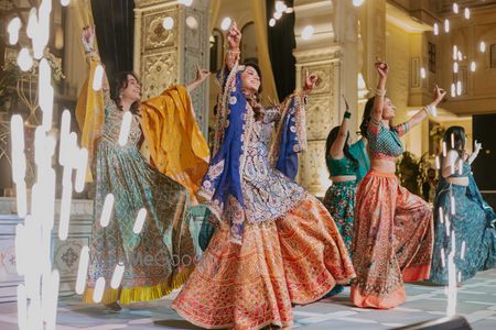 Photo of Fun shot of the bride dancing with her bridesmaids on the sangeet night on-stage