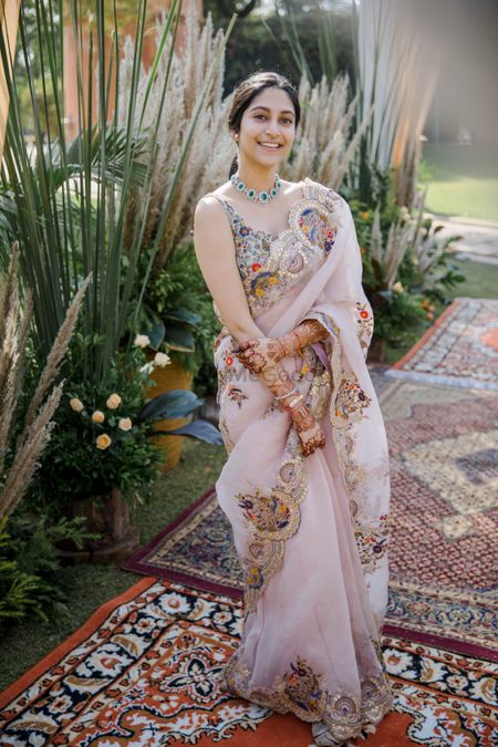 Bride wearing a pastel-hued organza saree. 