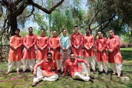 A groom with his groomsmen in coordinated outfits 