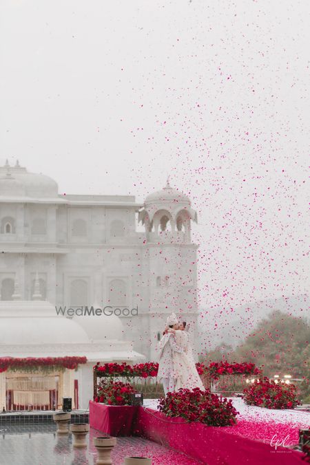 Photo of Palace wedding shot with the couple kissing after the jaimala.