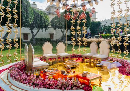 Stunning mandap decor for an outdoor wedding with lotus buds, unique props and floral elements