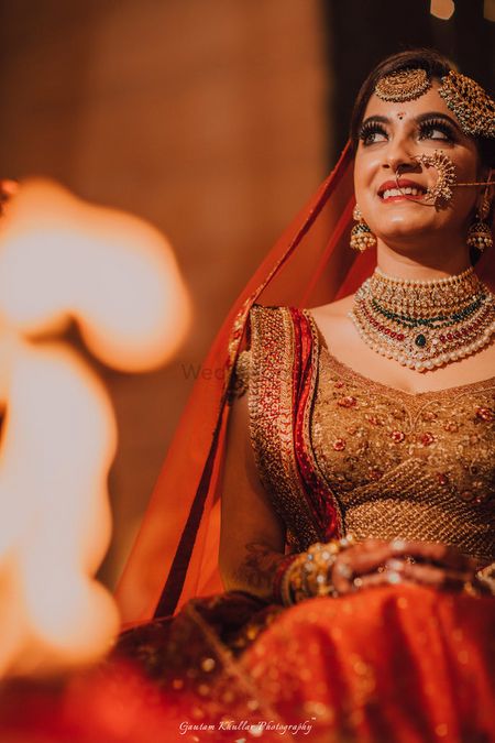 Photo of A bride in red lehenga with heavy jewellery