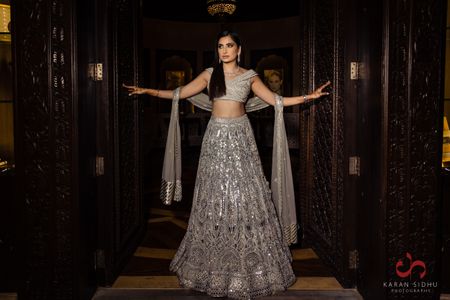 Bride wearing silver lehenga on her cocktail