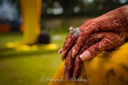 Solitaire engagement ring on mehendi hands