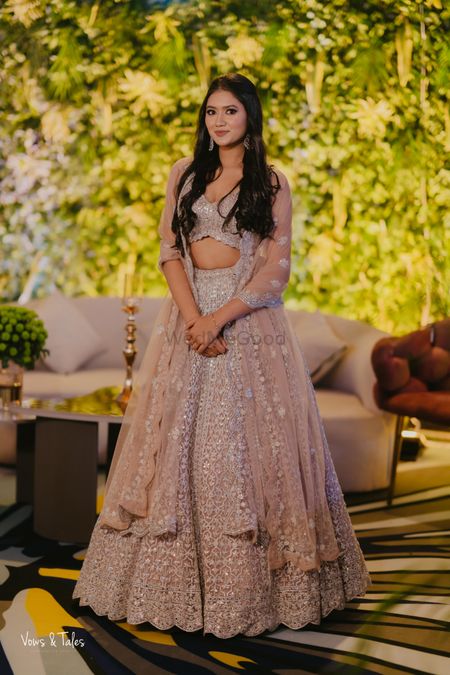 Gorgeous nude-hued lehenga with cape style dupatta draping for the bridesmaid