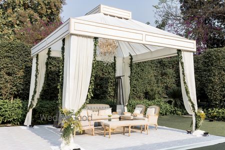 All white minimalistic outdoor wedding mandap with foliage decor