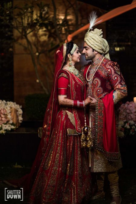 Traditional bride and groom in maroon outfits