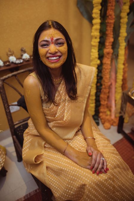 Bride wearing a yellow saree on her Haldi ceremony.