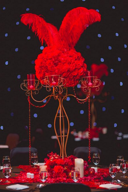Photo of black and red table centerpieces for sangeet moulin rouge theme