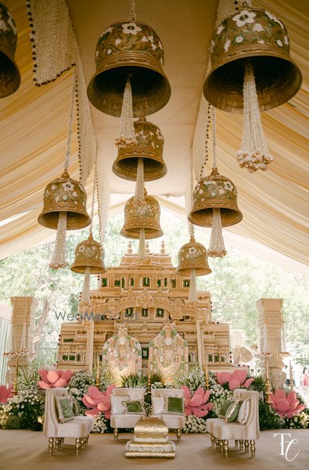 Gorgeous and very unique temple style bells with temple style mandap decor for the wedding day