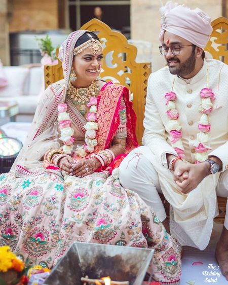 cute couple photo with the bride in a pastel pink sabyasachi lehenga