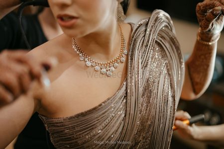Photo of Stunning grey and gold shimmering gown with a minimal diamond necklace