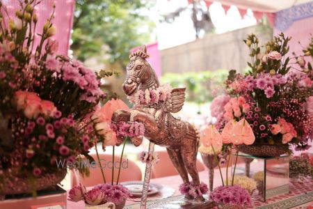 Unique and quirky horse centerpieces for table setting with pink flowers