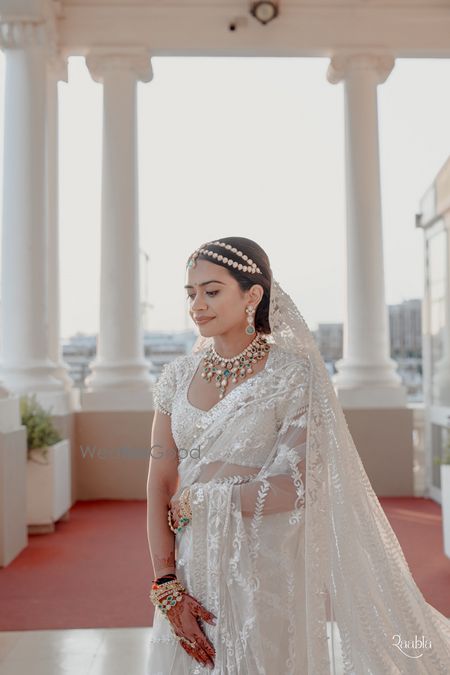 Photo of unique bridal jewellery in diamond and emerald detailing with two string mathapati