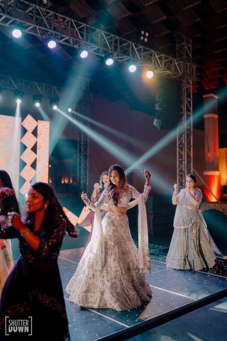 Photo of The bride dancing with her bridesmaids on sangeet