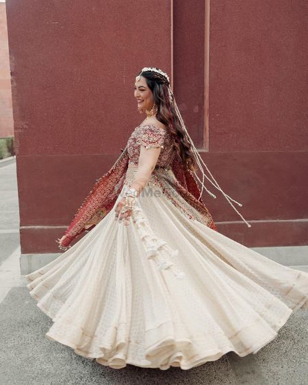 Photo of bride twirling in her haldi lehenga