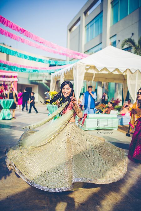 Photo of Mehendi twirling bride shot