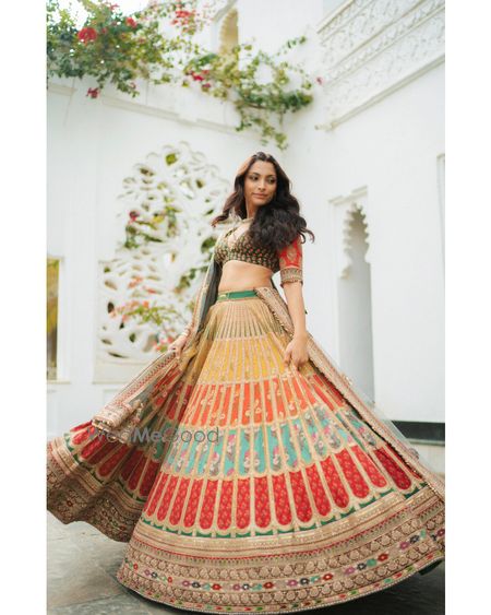 Gorgeous multi coloured lehenga with the bride twirling in it on her mehendi day