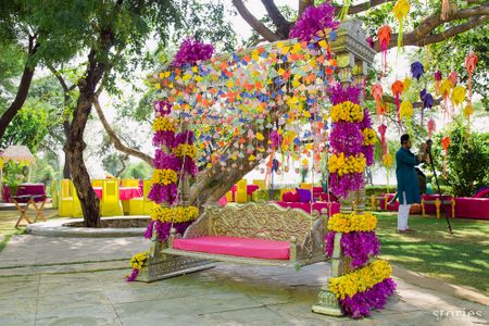 Photo of Quirky mehendi swing for bride with paper decor