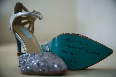 Message from groom under silver bridal shoe